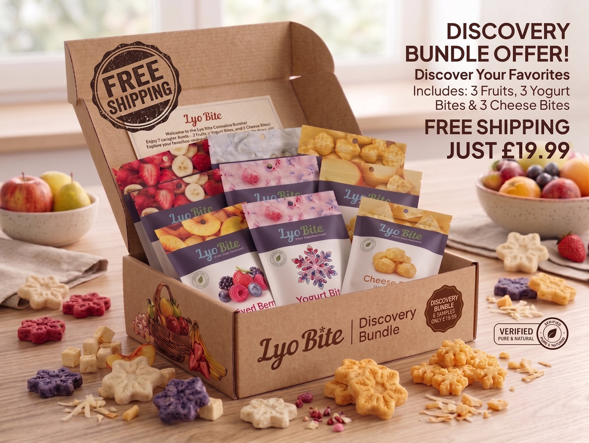 A Lyo Bite Discovery Bundle gift box filled with assorted fruit and yogurt bites, displayed on a wooden table with loose snack pieces around it. Promotional text on the right reads 'DISCOVERY BUNDLE OFFER! Discover Your Favorites! Includes: 3 Fruits, 3 Yogurt Bites & 3 Cheese Bites FREE SHIPPING JUST £19.99.